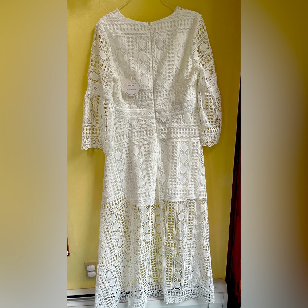 Lacy white dress, shorter in front long in back-bell like sleeves